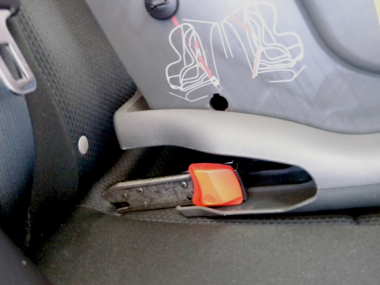 Rigid connectors being connected to ISOFIX low anchorages (not visible) in a vehicle